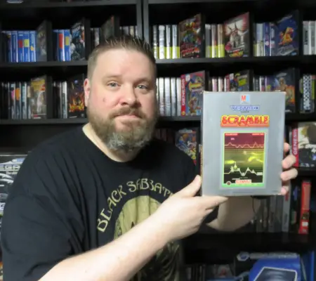 Me holding my copy of Scramble, one of my favourite games for the system